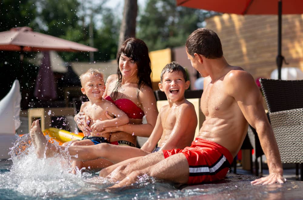 family with two kids enjoying their day swimming pool
